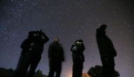 File Photo: People use night vision goggles to look at the night sky during an Unidentified Flying Object (UFO) tour in the desert outside Sedona, Arizona, February 14, 2013. (REUTERS/Mike Blake)
