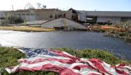 The American flag lies in the shrubs in front of the storm damaged Selma Country Club after a tornado ripped through Selma, Alabama, US, January 12, 2023. (Mickey Welsh/USA Today Network via REUTERS)