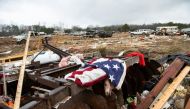 A flag is draped on the remnants of a home destroyed by a tornado on County Road 140 in Old Kingston, Alabama, US, January 13, 2023. (Jake Crandall/USA Today Network via REUTERS)