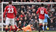 Manchester United's English striker Marcus Rashford (left) scores the team's second goal past Manchester City's Brazilian goalkeeper Ederson during the English Premier League football match between Manchester United and Manchester City at Old Trafford in Manchester, north west England, on January 14, 2023. (Photo by Oli SCARFF / AFP)