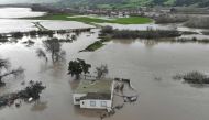 In an aerial view, a home is seen submerged in floodwater as the Salinas River begins to overflow its banks on January 13, 2023 in Salinas, California. Several atmospheric river events continue to pound California with record rainfall and high winds. Justin Sullivan/Getty Images/AFP