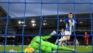 Brighton's English midfielder Solly March (centre right) score the opening goal past Liverpool's Brazilian goalkeeper Alisson Becker (L) during the English Premier League football match between Brighton and Hove Albion and Liverpool at the American Express Community Stadium in Brighton, southern England on January 14, 2023. - Brighton won the game 3-0. (Photo by Glyn KIRK / AFP) 