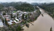 The Russian River, swollen with floodwater following a chain of winter storms, flows past the town of Guerneville, California, US on January 15, 2023. REUTERS/Fred Greaves