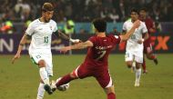 Iraq's defender Dhurgham Ismail (left) fights for the ball with Qatar's forward Ahmed Alaaeldin during the Arabian Gulf Cup semi-final football match between Iraq and Qatar at the Basra International Stadium in Iraq's southern city on January 16, 2023. (Photo by AHMAD AL-RUBAYE / AFP)