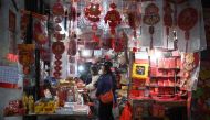 People shop for Lunar New Year decorations in the southern Chinese enclave of Macau ahead of the New Year of the Rabbit on January 17, 2023. (Photo by Peter Parks / AFP)