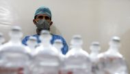 An employee of the National Oncology Center stands next to medicines at the center in Sanaa, Yemen, January 10, 2023. (REUTERS/Khaled Abdullah)