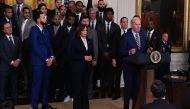 Golden State Warriors basketball player Stephen Curry, fellow members of the Golden State Warriors, and US Vice President Kamala Harris listen to US President Joe Biden speak during a celebration for the Golden State Warriors 2022 NBA championship, in the East Room of the White House in Washington, DC, on January 17, 2023. (Photo by Andrew CABALLERO-REYNOLDS / AFP)
 