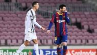  In this file photo taken on December 08, 2020 Juventus' Portuguese forward Cristiano Ronaldo walks past Barcelona's Argentinian forward Lionel Messi during the UEFA Champions League group G football match between Barcelona and Juventus at the Camp Nou stadium in Barcelona. (Photo by Josep LAGO / AFP)
 