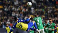 Al Nassr's Cristiano Ronaldo in action with Al Ettifaq's Saeed Al-Mowalad during the Saudi Pro League match between Al-Nassr and Al-Ettifaq at the King Fahd Stadium in the Saudi capital Riyadh on January 22, 2023. (REUTERS/Ahmed Yosri)