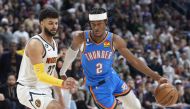 Oklahoma City Thunder guard Shai Gilgeous-Alexander, right, drives past Denver Nuggets guard Jamal Murray in the second half of an NBA basketball game Sunday, Jan. 22, 2023, in Denver. David Zalubowski / Associated Press
