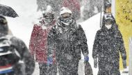 Pedestrians walk through the snow in Otaru, Hokkaido, on Saturday. Japan News-Yomiuri.
