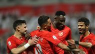 Michael Olunga celebrates with teammates after scoring a goal against Al Shamal.