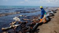 A worker cleans oil spills caused by a leak from an undersea pipeline 20 km (12.4 miles) off Thailand's eastern coast at Mae Ramphueng beach in Rayong province, Thailand, January 29, 2022. REUTERS/Soe Zeya Tun/File Photo