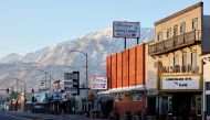 The rising sun illuminates downtown and the snow-covered Sierra Nevada mountains after a series of atmospheric river storms brought heavy snowfall to the mountain range on January 22, 2023 in Bishop, California. (Mario Tama/Getty Images/AFP)