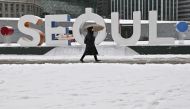 Woman walking along snow-covered street in front of City Hall in Seoul, South Korea. File photo for representational purposes only.