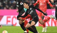 Frankfurt's Japanese midfielder Makoto Hasebe (front) and Bayern Munich's German midfielder Jamal Musiala vie for the ball during the German Bundesliga football match between Bayern Munich and Eintracht Frankfurt in Munich, southern Germany, on January 28, 2023.