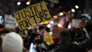 People hold signs during a protest following the release of videos showing Memphis police officers beating Tyre Nichols, who died while hospitalized three days later, in New York, U.S., January 28, 2023. REUTERS/David Dee Delgado