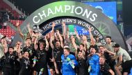 Germany's players pose with the trophy after winning the FIH men's hockey World Cup 2023 final match against Belgium at the Kalinga Stadium in Bhubaneswar, India, on January 29, 2023. (Photo by DIBYANGSHU SARKAR / AFP)