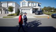A couple walks in front of the house where former Brazilian President Jair Bolsonaro is staying, in Kissimmee, Florida, US, on January 11, 2023. REUTERS/Marco Bello/File Photo