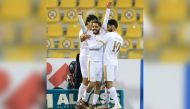 Qatar SC's Nasir Peer Baksh celebrates with teammates after scoring their second goal against Al Arabi, yesterday.