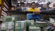 A man counts Lebanese pound banknotes at an exchange shop in Beirut, Lebanon, January 11, 2023. (REUTERS/Mohamed Azakir)