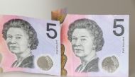 Australian $5 banknotes with a portrait of the late Queen Elizabeth II are seen in this picture illustration taken February 2, 2023. REUTERS/Loren Elliott/Illustration