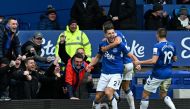 Everton's  defender James Tarkowski (centre) celebrates with teammates after scoring a goal during the English Premier League match between Everton and Arsenal at Goodison Park in Liverpool, north-west England, on February 4, 2023. (Photo by Paul ELLIS / AFP) 