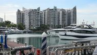 This picture taken on February 1, 2023 shows Sentosa Cove private residential housing next to yachts docked at One 15 Marina Sentosa Cove in Singapore. (Photo by Roslan RAHMAN / AFP)
