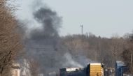 Smoke rises from a derailed cargo train in East Palestine, Ohio, on February 4, 2023. (Photo by Dustin Franz / AFP)