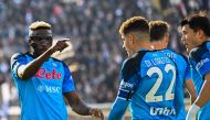 Napoli's Nigerian forward Victor Osimhen (left) celebrates after scoring during the Italian Serie A football match between Spezia and Napoli on February 5, 2023 at the Alberto-Picco stadium in La Spezia. (Photo by Alberto PIZZOLI / AFP)