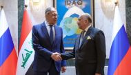 Russian Foreign Minister Sergei Lavrov (left) and his Iraq's counterpart Fuad Hussein pose for photos as they arrive for a meeting at the foreign ministry in Baghdad on February 6, 2023. (Handout / RUSSIAN FOREIGN MINISTRY / AFP)