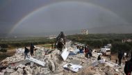 Residents search for victims and survivors amidst the rubble of collapsed buildings in the village of Besnaya in Syria, on February 6, 2022. (Photo by Omar Haj Kadour / AFP)