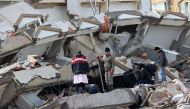 Civilians look for survivors under the rubble of collapsed buildings in Kahramanmaras, close to the quake's epicentre. (Photo by Adem Altan / AFP)