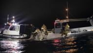 This picture provided by the US Navy shows sailors assigned to Explosive Ordnance Disposal Group 2 recover a high-altitude surveillance balloon off the coast of Myrtle Beach, South Carolina, in the Atlantic ocean on February 5, 2023.  (Photo by Petty Officer 1st Class Tyler Thompson / US NAVY / AFP) 