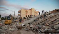 A photo taken on on February 8, 2023, shows residents and rescue personnel searching for victims and survivors through the rubble of collapsed buildings in Adiyaman, two days after a 7,8-magnitude earthquake struck southeast Turkey.  Photo by ILYAS AKENGIN / AFP