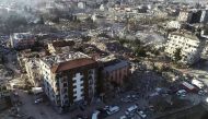This aerial view shows a collapsed building during ongoing rescue searches in Hatay, southeastern Turkey, on February 9, 2023, two days after a strong earthquake struck the region. (Photo by DHA (Demiroren News Agency) / AFP)