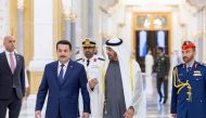 A handout picture released by the United Arab Emirates' presidential court shows Emirati President Sheikh Mohamed bin Zayed Al-Nahyan welcoming Iraq's Premier Mohamed Shia al-Sudani in Abu Dhabi on February 9, 2023. (Photo by UAE PRESIDENTIAL COURT / AFP)