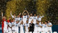 Real Madrid's players celebrate with the trophy at the end of the FIFA Club World Cup final football match between Spain's Real Madrid and Saudi Arabia's Al-Hilal at the Prince Moulay Abdellah Stadium in Rabat on February 11, 2023. - Real Madrid lifted the Club World Cup for a record fifth time with a pulsating 5-3 win over Al-Hilal. (Photo by Khaled DESOUKI / AFP)