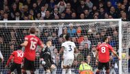 Manchester United's English striker Marcus Rashford (left) scores the opening goal of the English Premier League match between Leeds United and Manchester United at Elland Road in Leeds, northern England on February 12, 2023. (Photo by Oli SCARFF / AFP)