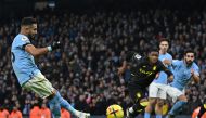 Manchester City's Algerian midfielder Riyad Mahrez scores their third goal from the penalty spot during the English Premier League match between Manchester City and Aston Villa at the Etihad Stadium in Manchester, north west England, on February 12, 2023. (Photo by Paul ELLIS / AFP)