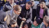 A handout picture released by the official Syrian Arab News Agency (SANA) on February 11, 2023, shows Syria's President Bashar al-Assad (right) and first lady Asma al-Assad (left) visiting families affected by the earthquake, at the Basil Al-Assad Center for Educational Training in Latakia, on February 11, 2023. (Photo by SANA / AFP) 