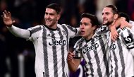 Juventus' French midfielder Adrien Rabiot (right) celebrates with Juventus' Serbian forward Dusan Vlahovic (left) and Juventus' Italian forward Federico Chiesa after opening the scoring during the Italian Serie A football match between Juventus and Fiorentina on February 12, 2023 at the Juventus stadium in Turin. (Photo by Marco BERTORELLO / AFP)