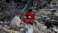 This photograph shows a teddy bear on the rubble of a collapsed building on February 12, 2023 in Kahramanmaras, as rescue teams starts to wind down their work after a 7.8 magnitude earthquake struck the border region of Turkey and Syria. (Photo by OZAN KOSE / AFP)