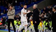 Real Madrid's French forward Karim Benzema shakes hands with Real Madrid's Italian coach Carlo Ancelotti as he leaves the pitch during the Spanish League match between Real Madrid CF and Elche CF at the Santiago Bernabeu stadium in Madrid on February 15, 2023. (Photo by JAVIER SORIANO / AFP)
