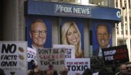 (FILES) In this file photo taken on March 13, 2019 protesters rally against Fox News outside the Fox News headquarters at the News Corporation building in New York City. - Media titan Rupert Murdoch described Donald Trump's claims that the 2020 election was stolen as 
