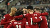 Liverpool's striker Cody Gakpo (center) celebrates after scoring his team second goal during the English Premier League match between Newcastle United and Liverpool at St James' Park in Newcastle-upon-Tyne, north east England on February 18, 2023. (Photo by Oli SCARFF / AFP)