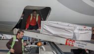 The coffin containing the body of former Ghana international football player Christian Atsu is loaded into an airplane bound for Ghana, at Adana airport in southern Turkey, February 18, 2023. (Photo by CAN EROK / AFP) 