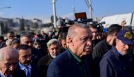 Turkish President Recep Tayyip Erdogan walks through the crowd as he visits the hard-hit southeastern province of Hatay, the seen of destruction following two earthquakes on February 20, 2023.  (Photo by Yasin AKGUL / AFP)
  