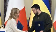Ukrainian President Volodymyr Zelensky and Italian Prime Minister Giorgia Meloni shake hands before a joint press conference after their meeting in Kyiv on February 21, 2023. (Photo by Genya Savilov / AFP)