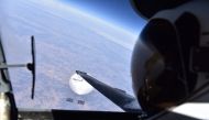 In this handout photo provided by the US Department of Defense on February 22, 2023, a US Air Force pilot looks down at the suspected Chinese surveillance balloon as it hovers over the Central Continental United States on February 3, 2023. Photo by US Department of Defense / AFP